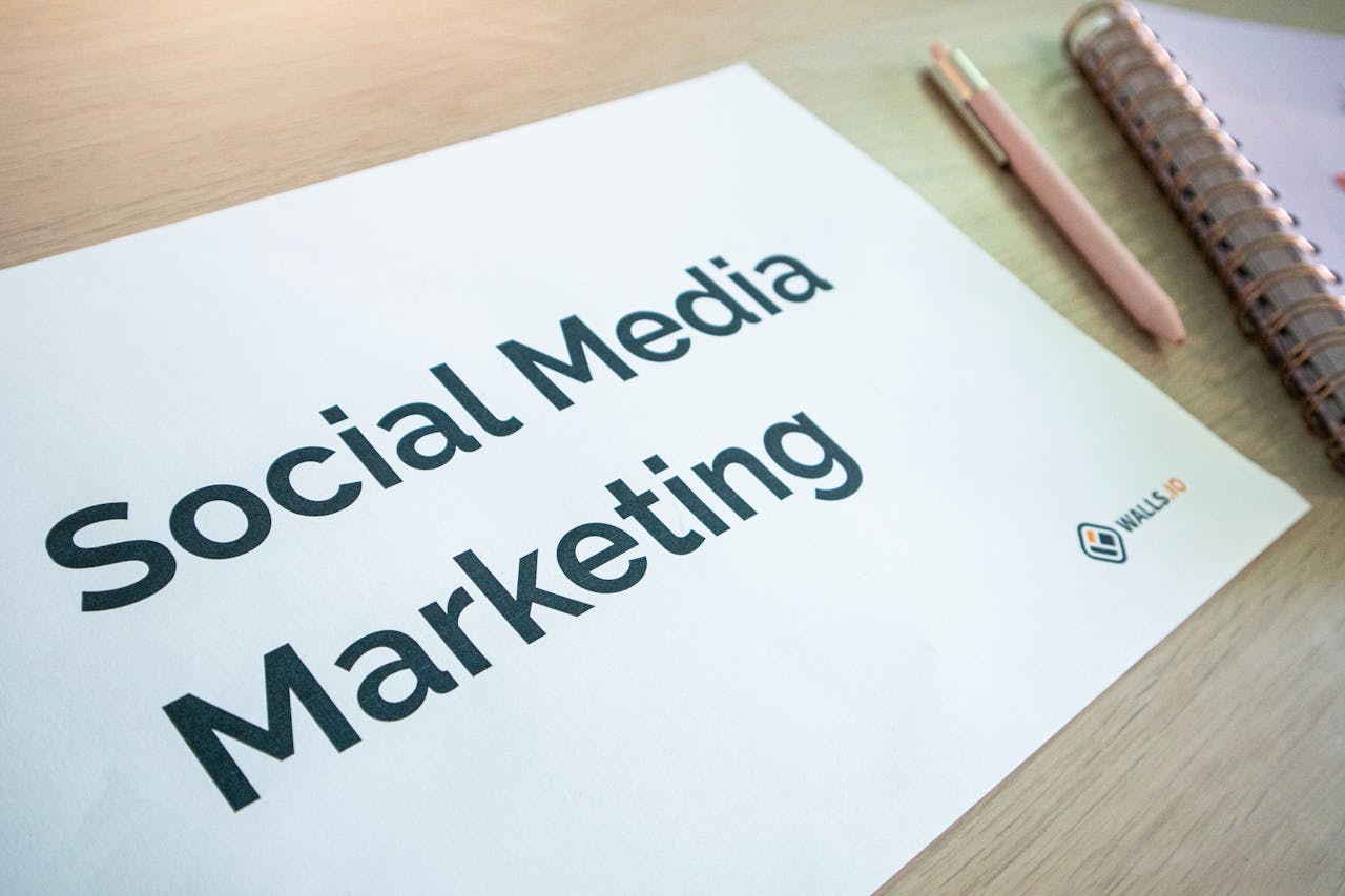 cta-bg Close-up of a social media marketing document on a desk with a pen and notebook.